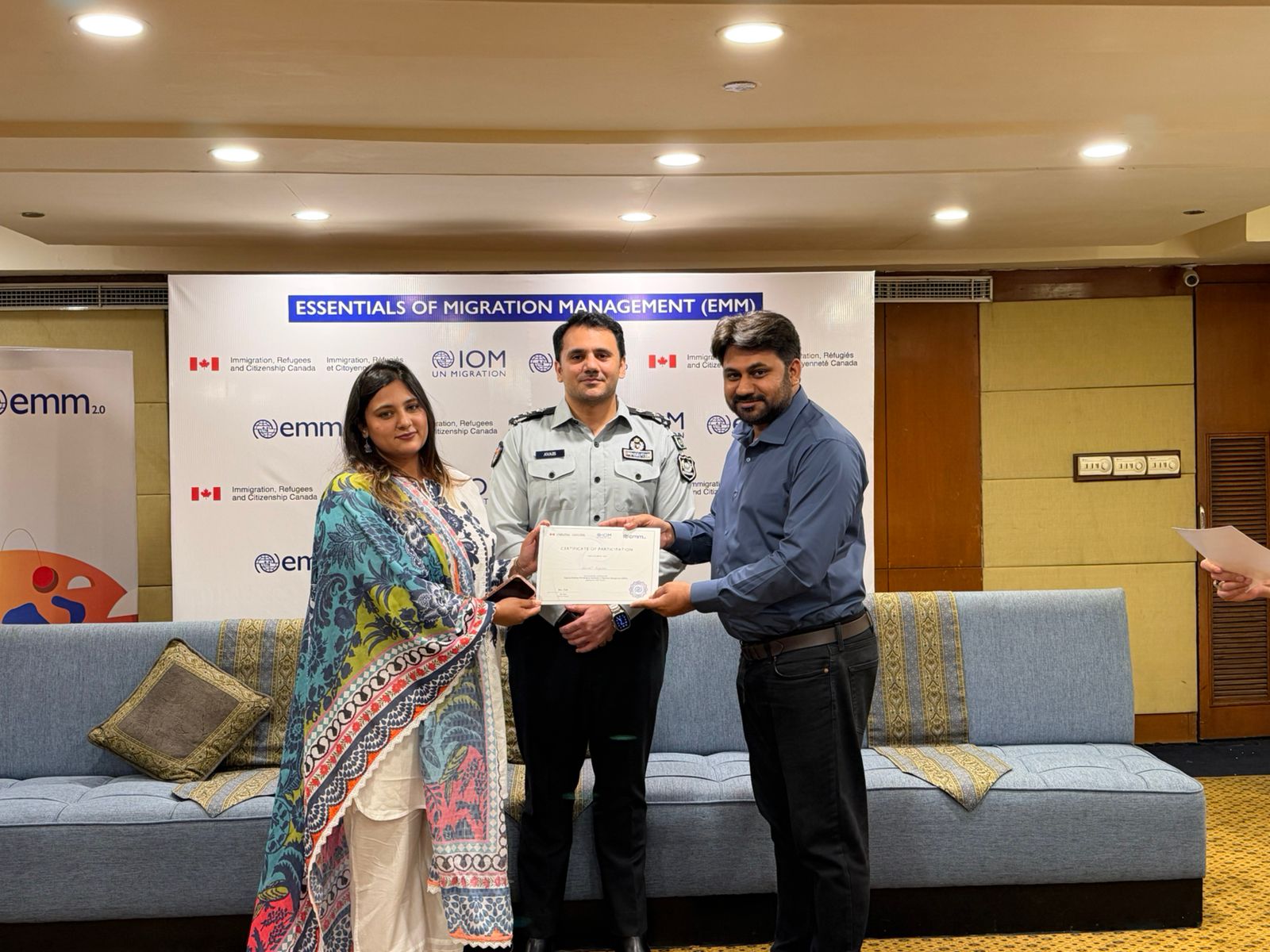 Participant receiving certificate at EMM 2.0 closing ceremony
